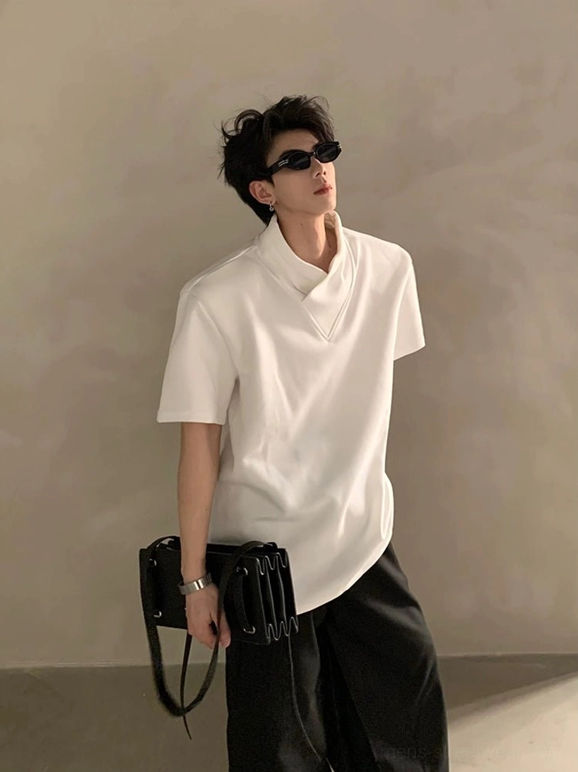 White layered high-collar short-sleeve streetwear shirt with asymmetric hem on male model wearing sunglasses and crossbody bag
