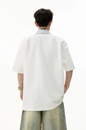 Back view of white oversized layered V-placket polo tee showing the clean solid-color relaxed streetwear silhouette