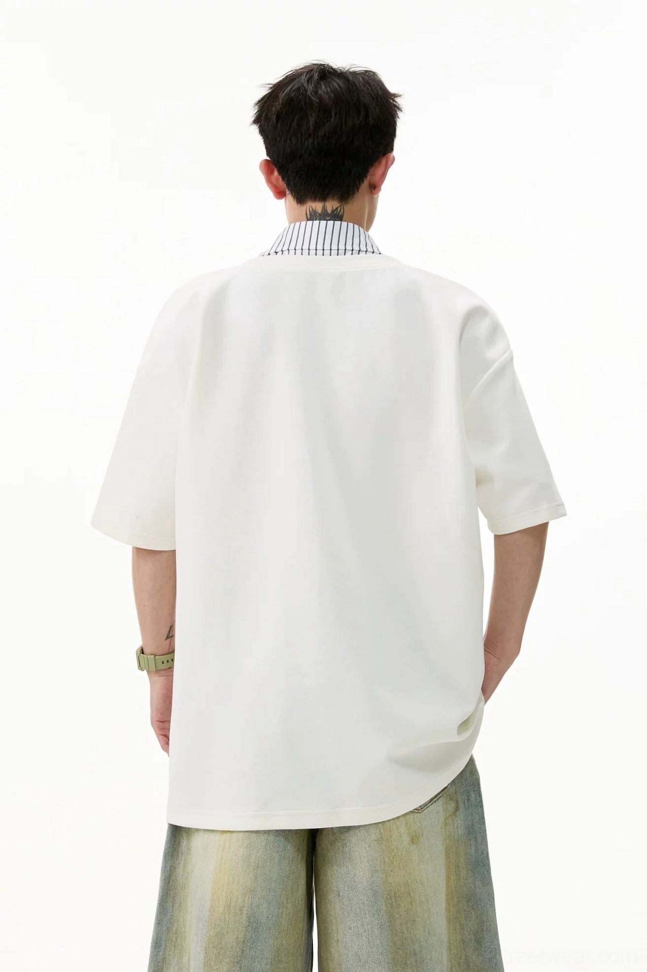 Back view of white oversized layered V-placket polo tee showing the clean solid-color relaxed streetwear silhouette