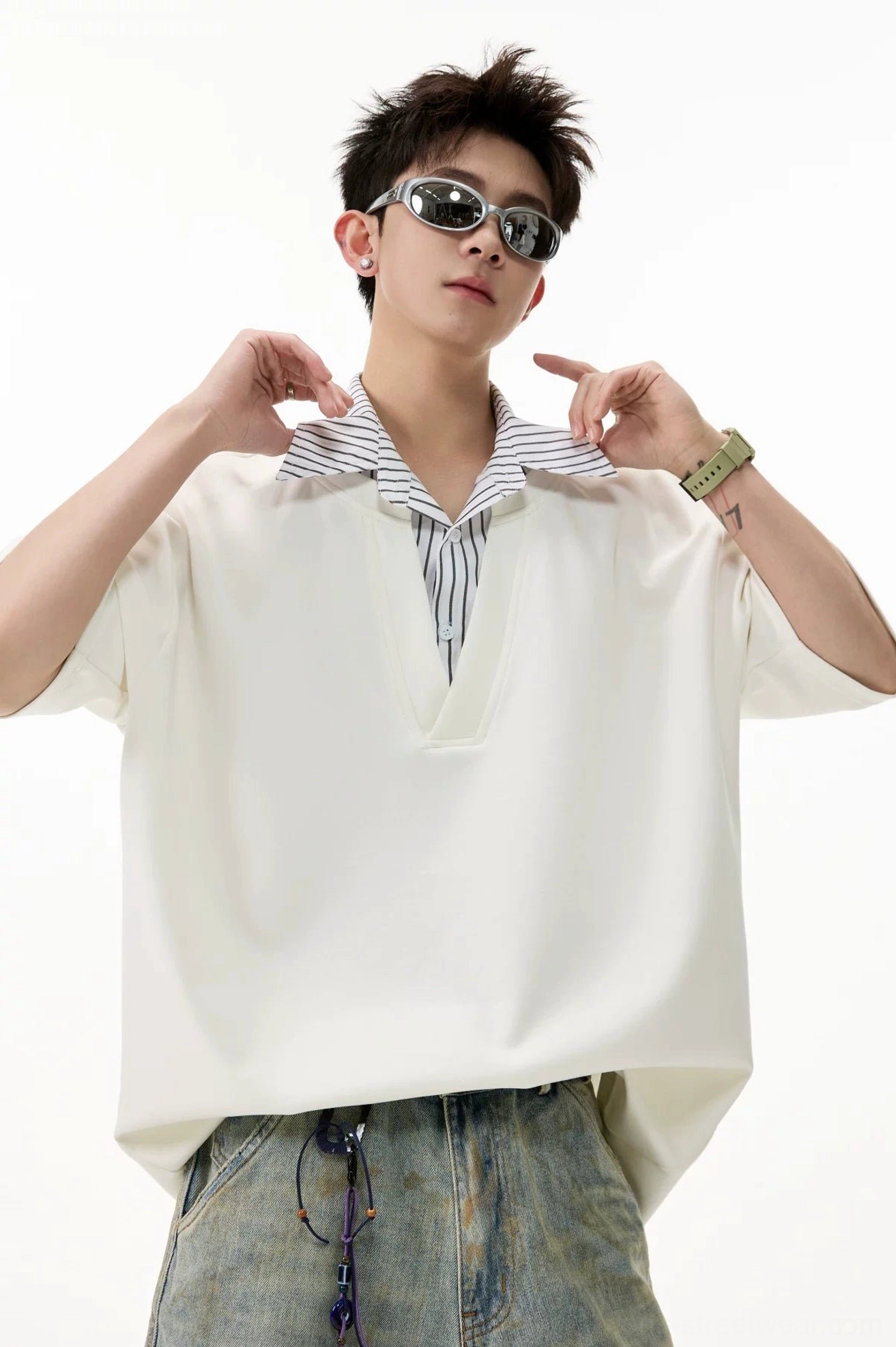 Close-up of white layered V-placket polo tee with sewn-in fine striped shirt collar and oversized dropped shoulders
