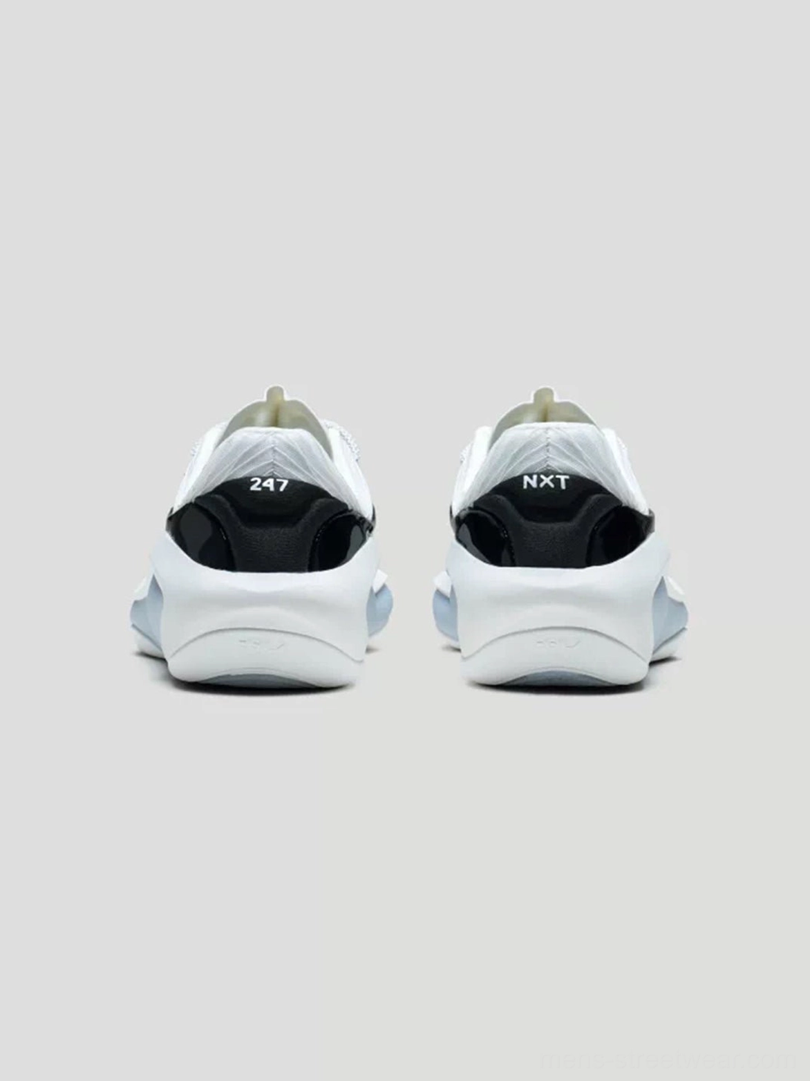 Rear view of white leather basketball sneakers showing black heel counters and cushioned translucent midsole