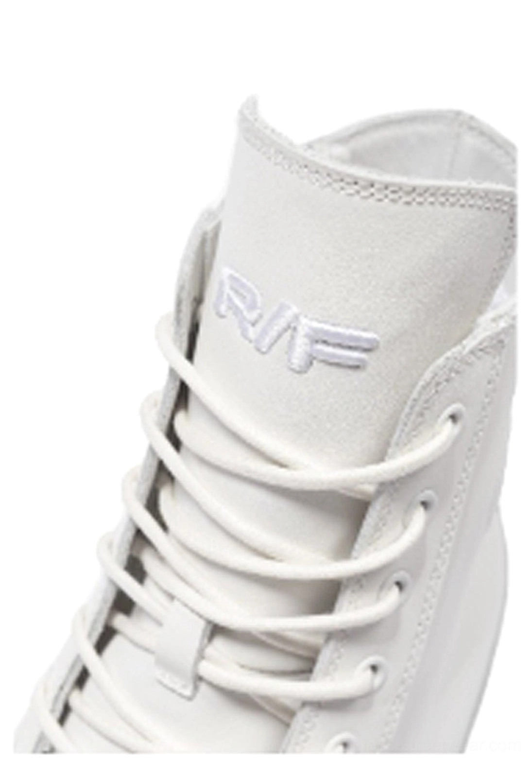 Close-up of white leather high-top boot upper showing matching flat laces, evenly spaced eyelets, and detailed ankle stitching