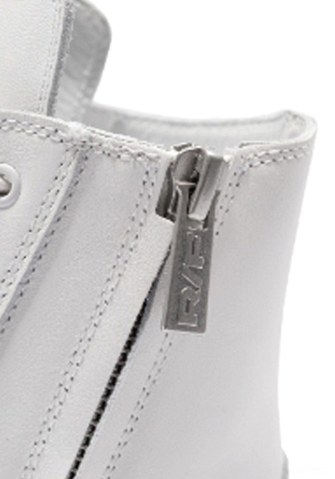 Close-up side view of white leather high-top boot with metal side zipper pull, neat topstitching, and modern streetwear construction
