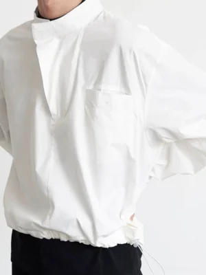 Side view of white long sleeve asymmetric stand collar pullover shirt with concealed placket and adjustable drawstring hem