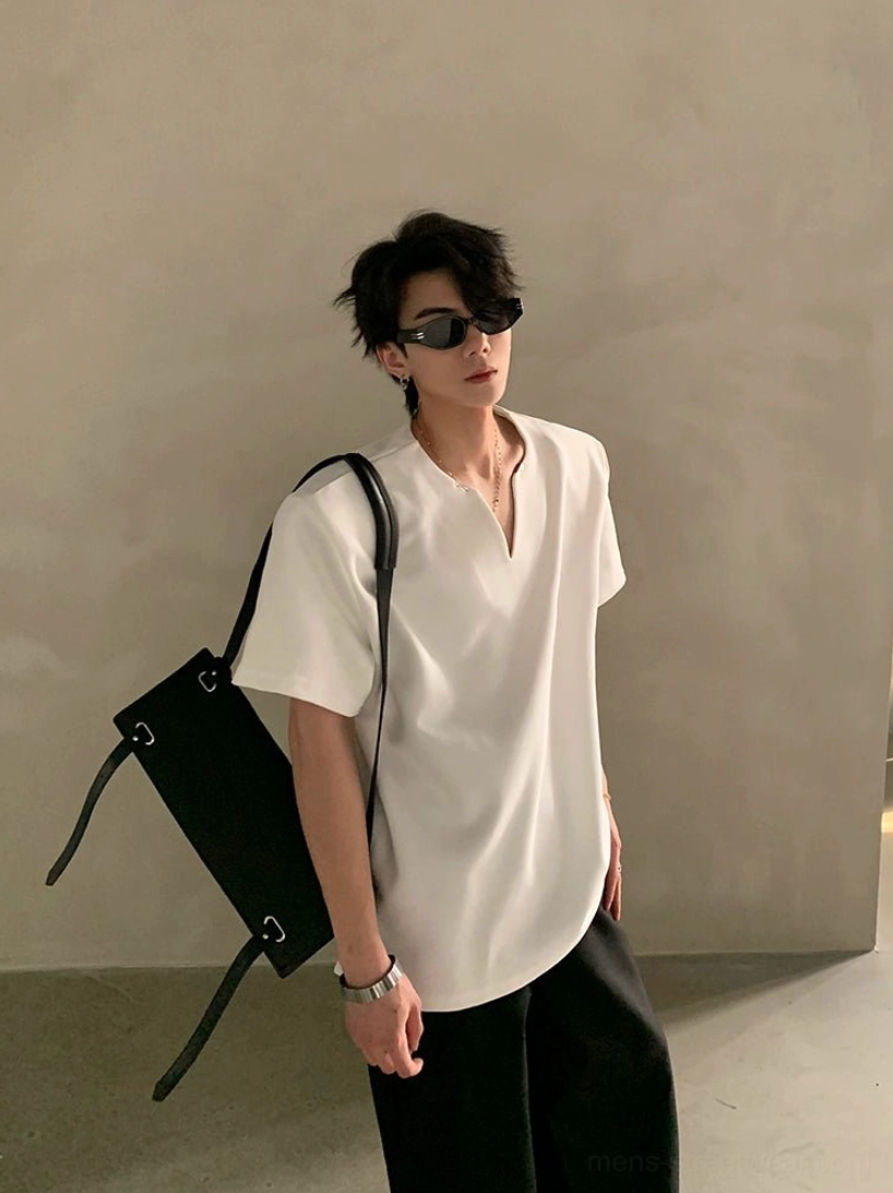 White loose-fit minimalist V-notch neck short sleeve shirt with smooth fabric texture styled in a clean Korean streetwear outfit