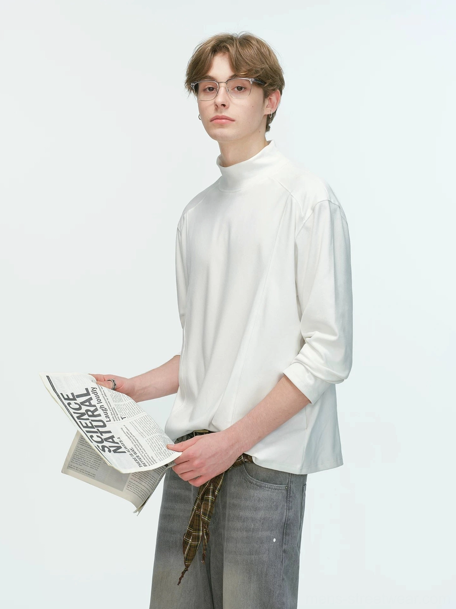 White men's mock neck long sleeve top with rolled cuffs styled with faded gray wide-leg jeans in a minimalist Seoul fashion outfit