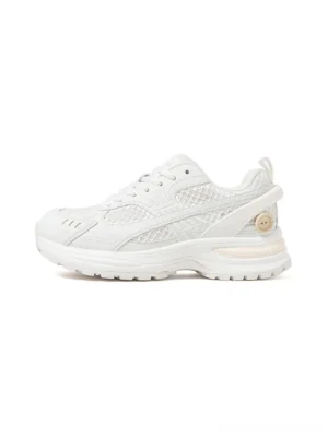 White mesh sculpted-sole runner sneakers shown in a clean left-side studio view with layered breathable panels, chunky technical outsole, and rear heel accent