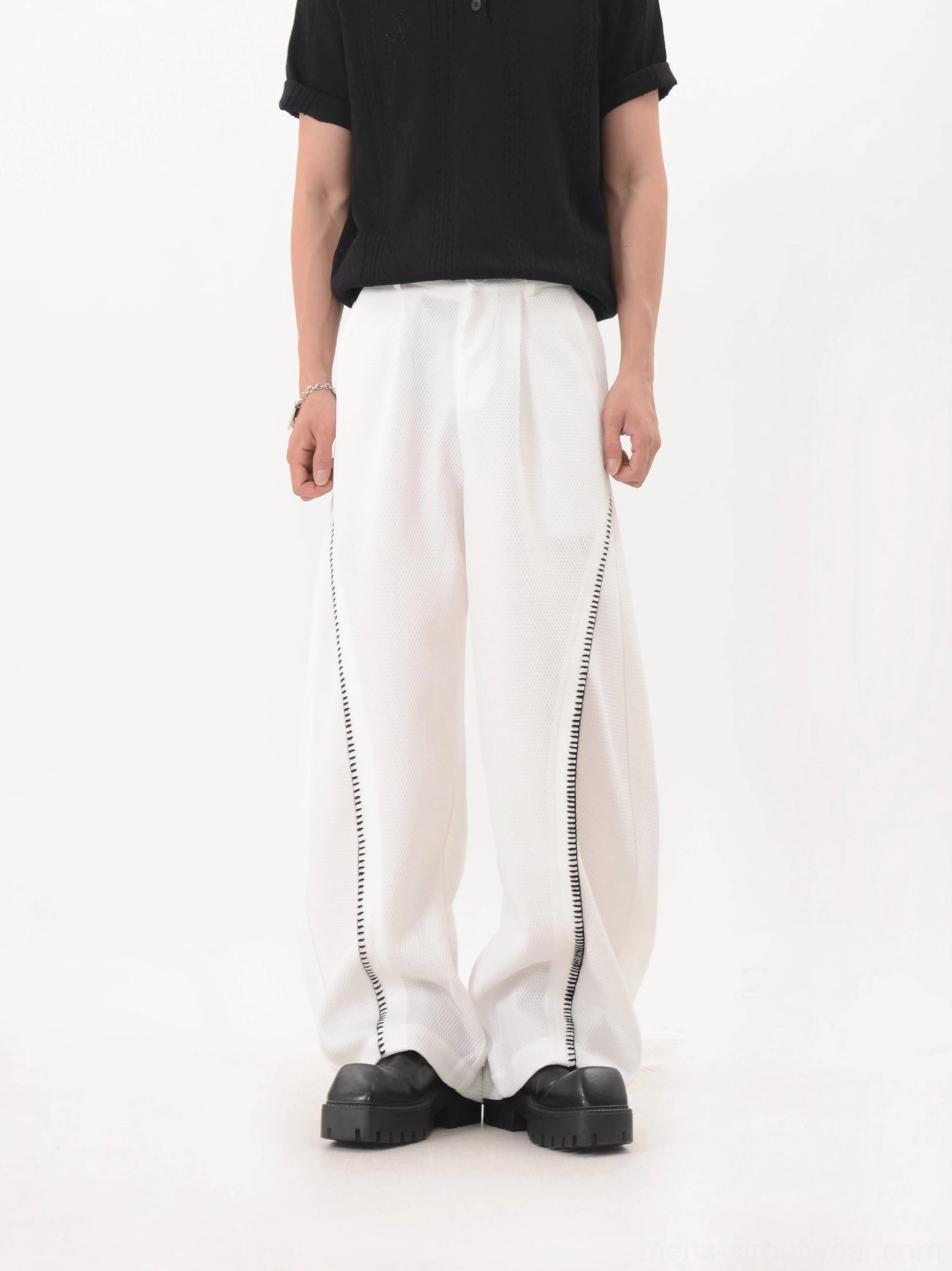 White mesh texture wide leg techwear trousers with subtle curved trim and clean tailored loose silhouette