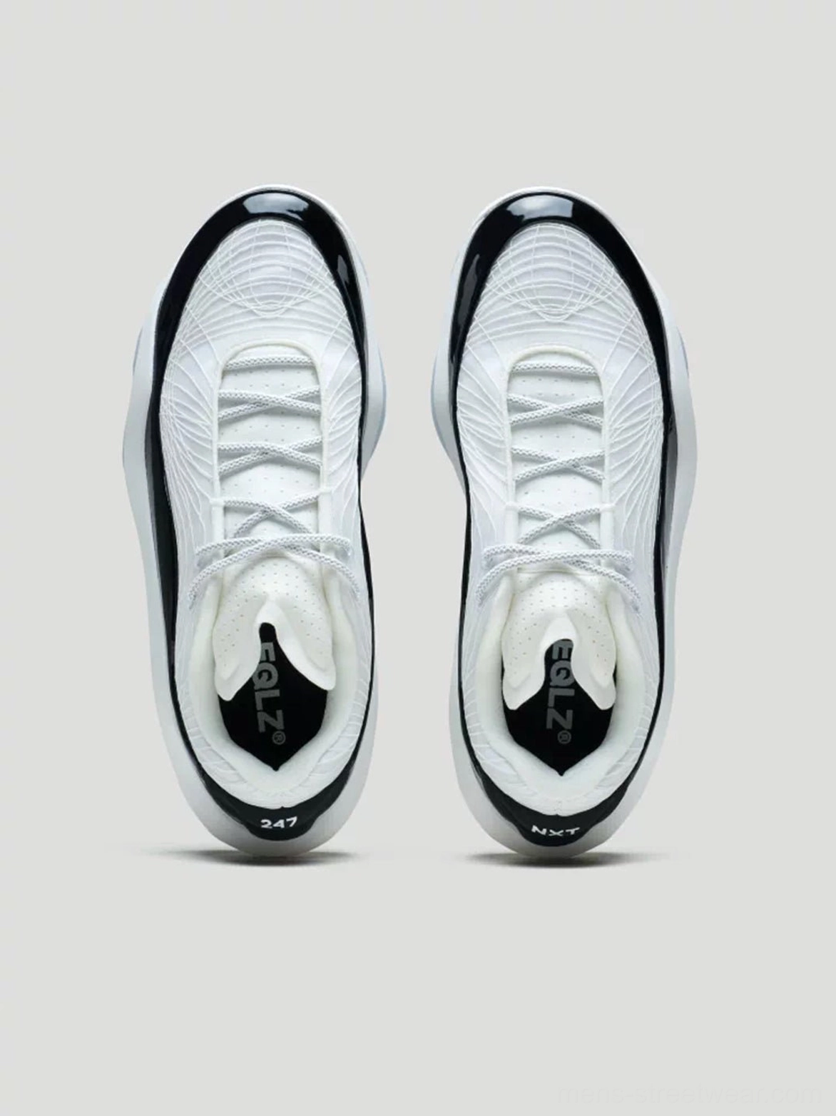 Top-down pair view of white molded knit basketball sneakers showing textured upper black accents and cushioned insole