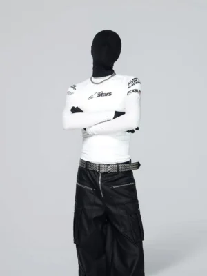 White fitted motorsport long sleeve streetwear tee styled with wide-leg cargo pants and a studded belt