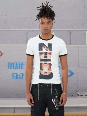 Front view of white NERD photo collage ringer T-shirt with black contrast collar and sleeve cuffs styled with black work denim