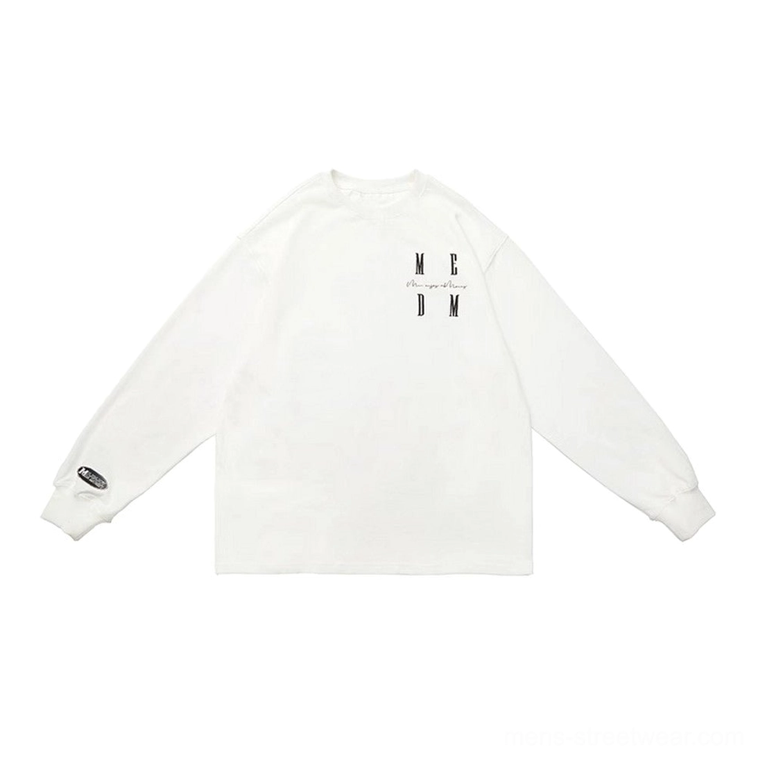 White oversized cotton long sleeve T-shirt flat lay showing chest MCDM lettering, crew neck, and cuff detail