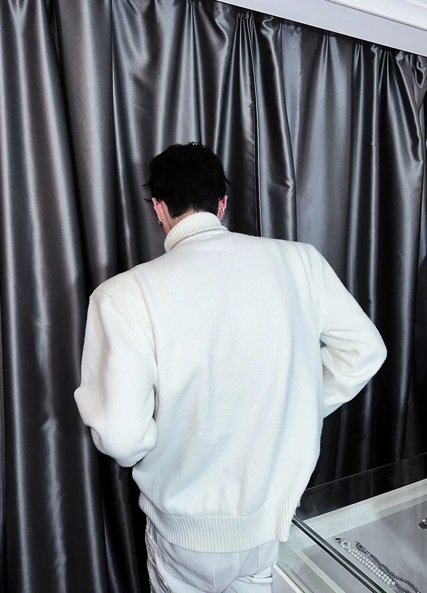 Back view of white oversized half-zip turtleneck sweater with ribbed collar and hem