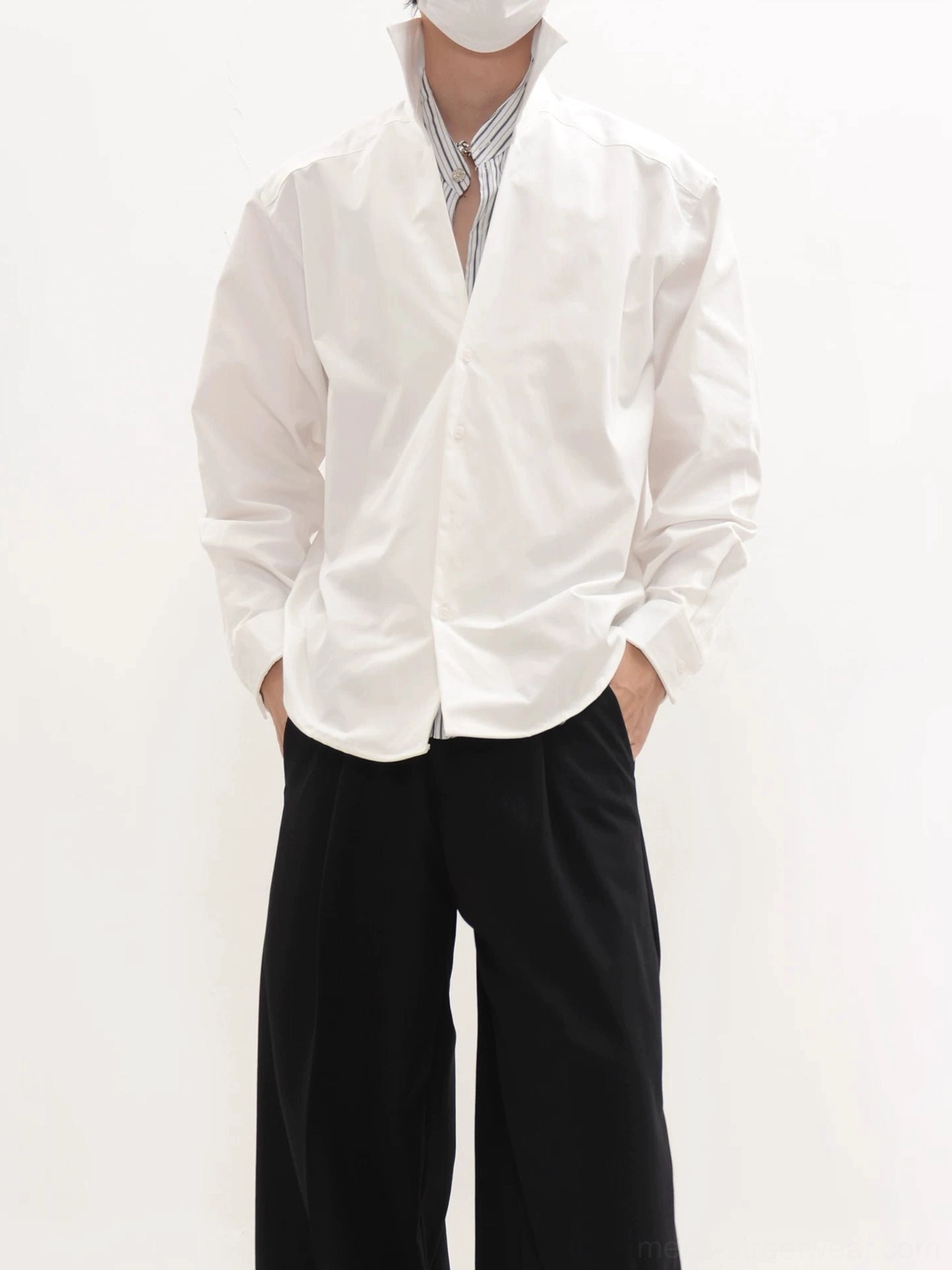 White oversized longline button-up shirt with raised collar and striped layered inner shirt streetwear outfit