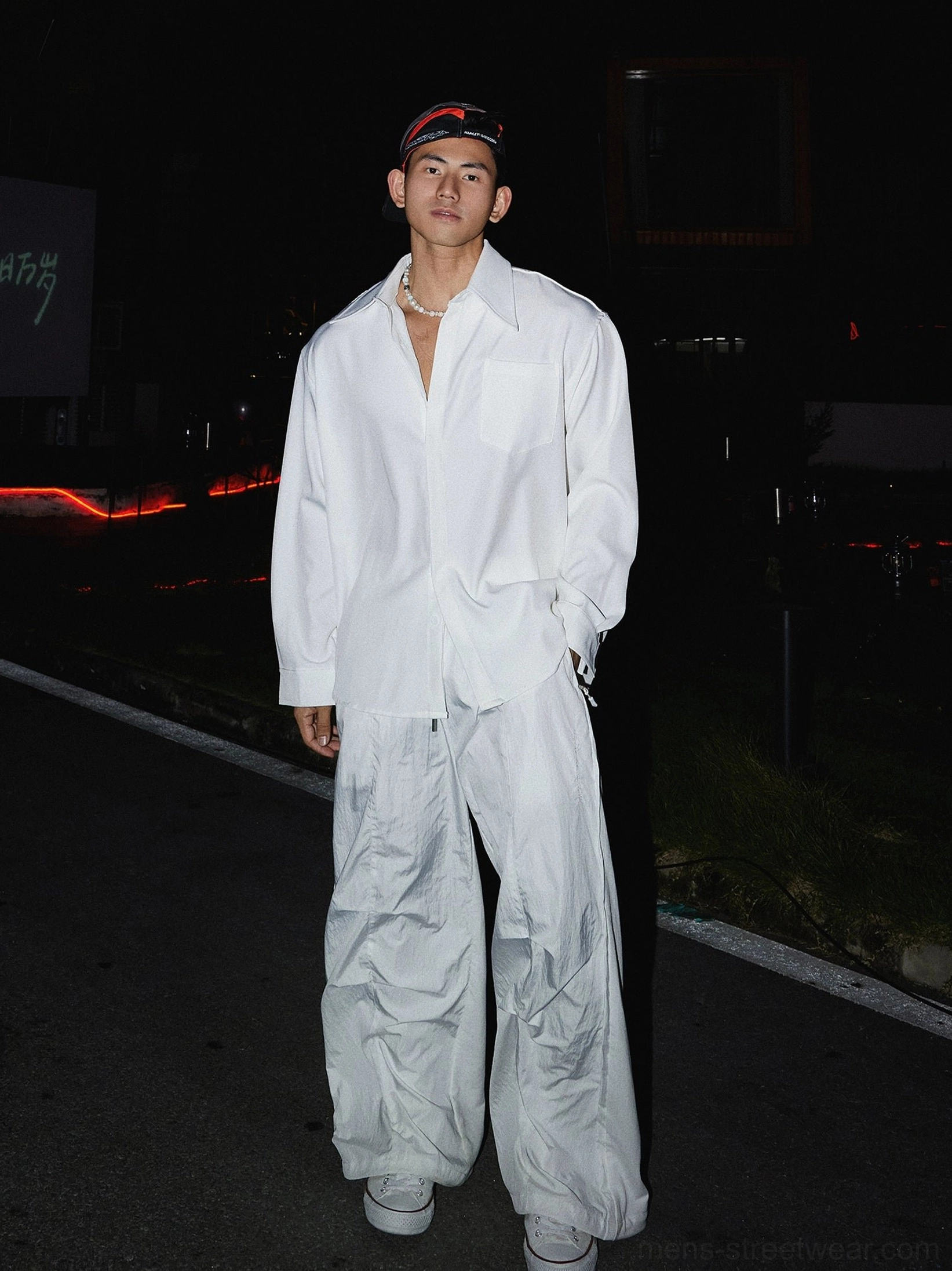 White oversized men's streetwear shirt styled with wide-leg white pants and sneakers in a modern Seoul fashion outfit