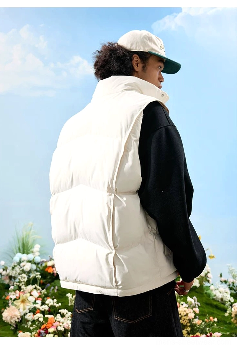 Rear three quarter view of a white oversized puffer vest showing quilted back panels, sleeveless cut, and high stand collar