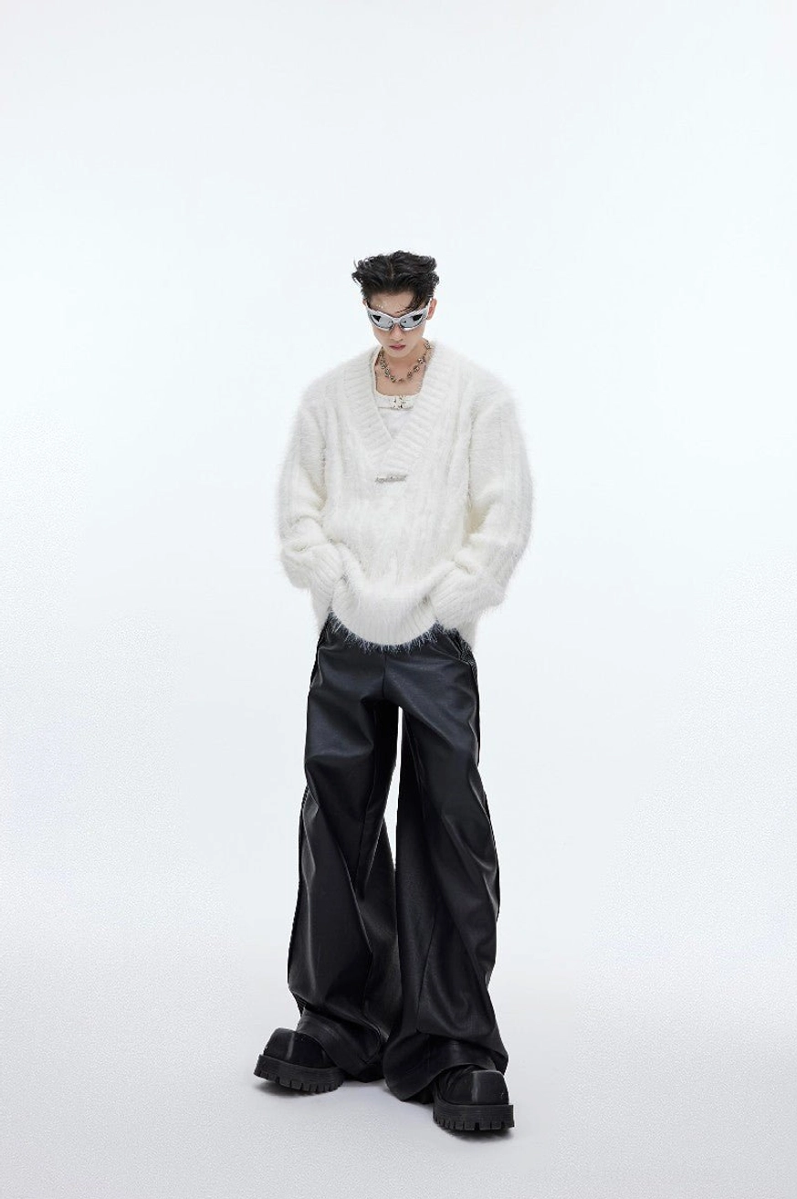 Full front view of white oversized shaggy faux-fur V-neck sweater with plush texture, relaxed sleeves, and metal neckline detail