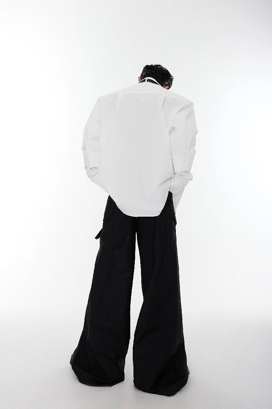 White oversized shoulder pad streetwear shirt back view showing relaxed long sleeves and clean oversized silhouette