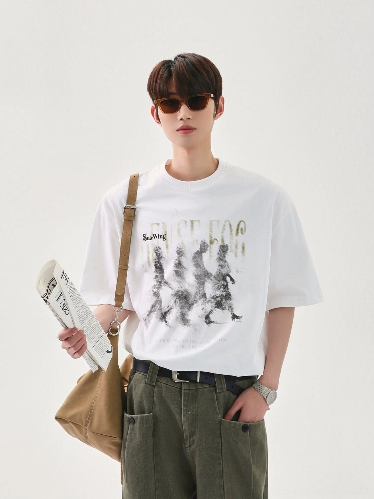 White oversized graphic T-shirt with blurred vintage marching figure print, dropped shoulders, canvas shoulder bag styling, and Seoul streetwear fit