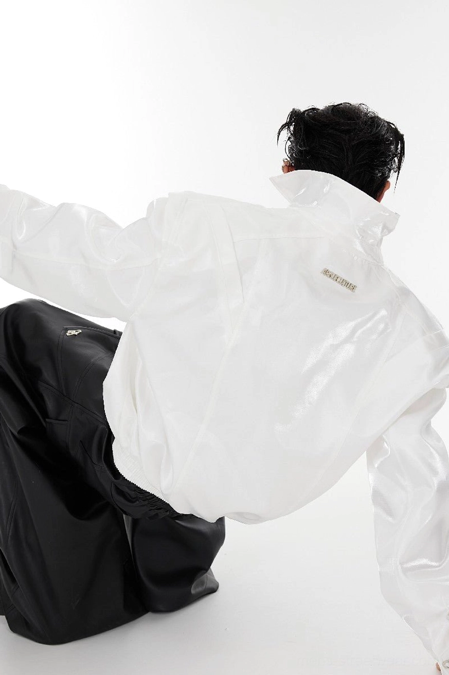 White padded shoulder vegan leather cropped jacket rear view showing smooth glossy streetwear finish and structured collar