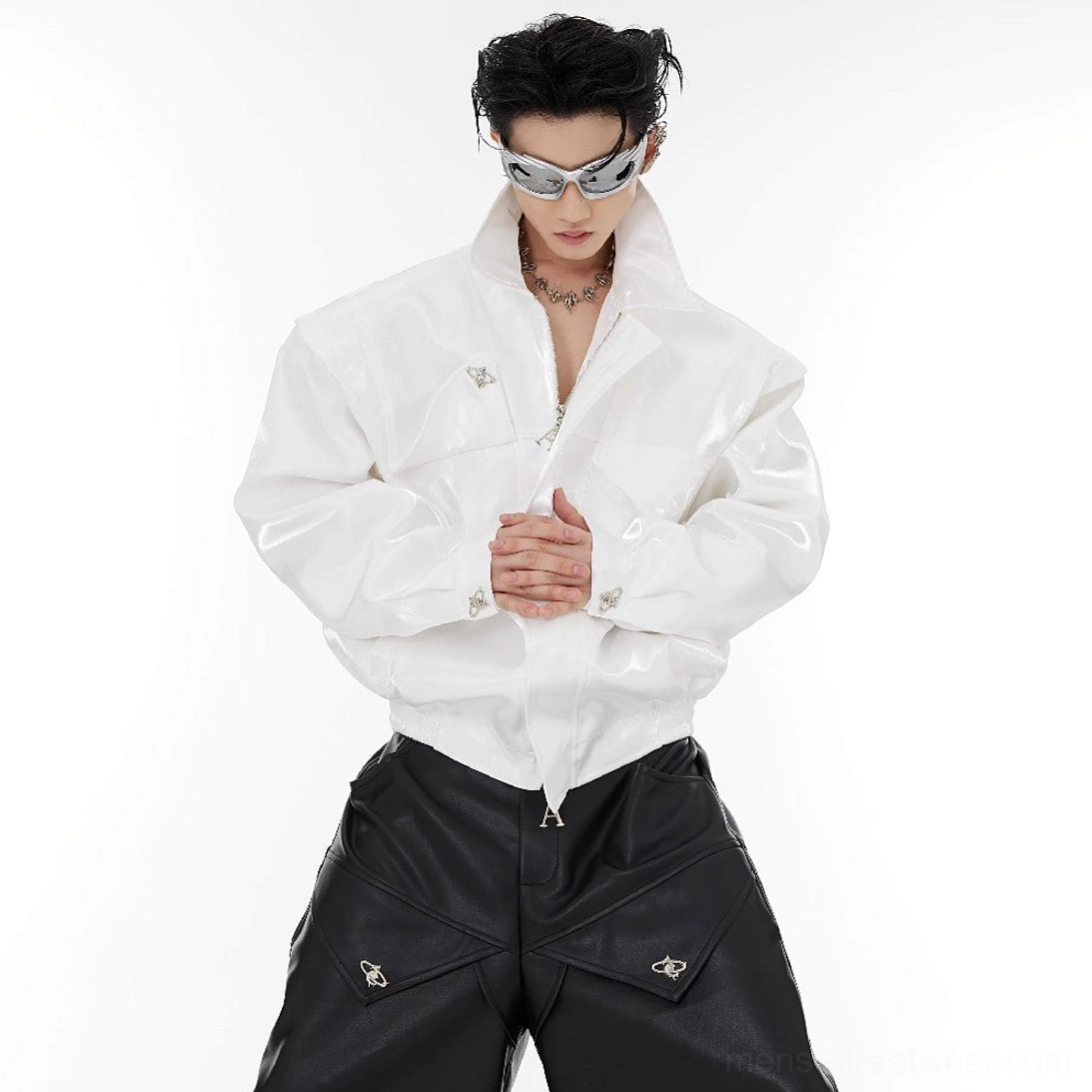 White padded shoulder vegan leather cropped jacket close-up with glossy finish, half zip front and button cuff details