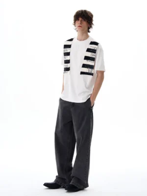 White patch-panel graphic T-shirt styled with grey wide-leg denim for a modern Seoul streetwear outfit