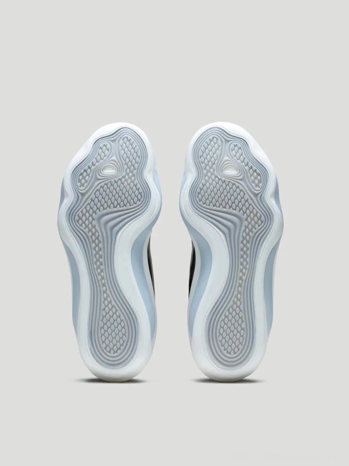 Top-down view of patterned rubber traction outsoles on white PEBAX basketball sneakers with translucent blue midsole edges