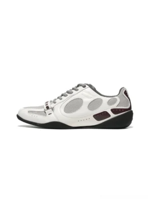 White perforated retro sport sneakers with burgundy and black contrast trim shown in a three-quarter studio view