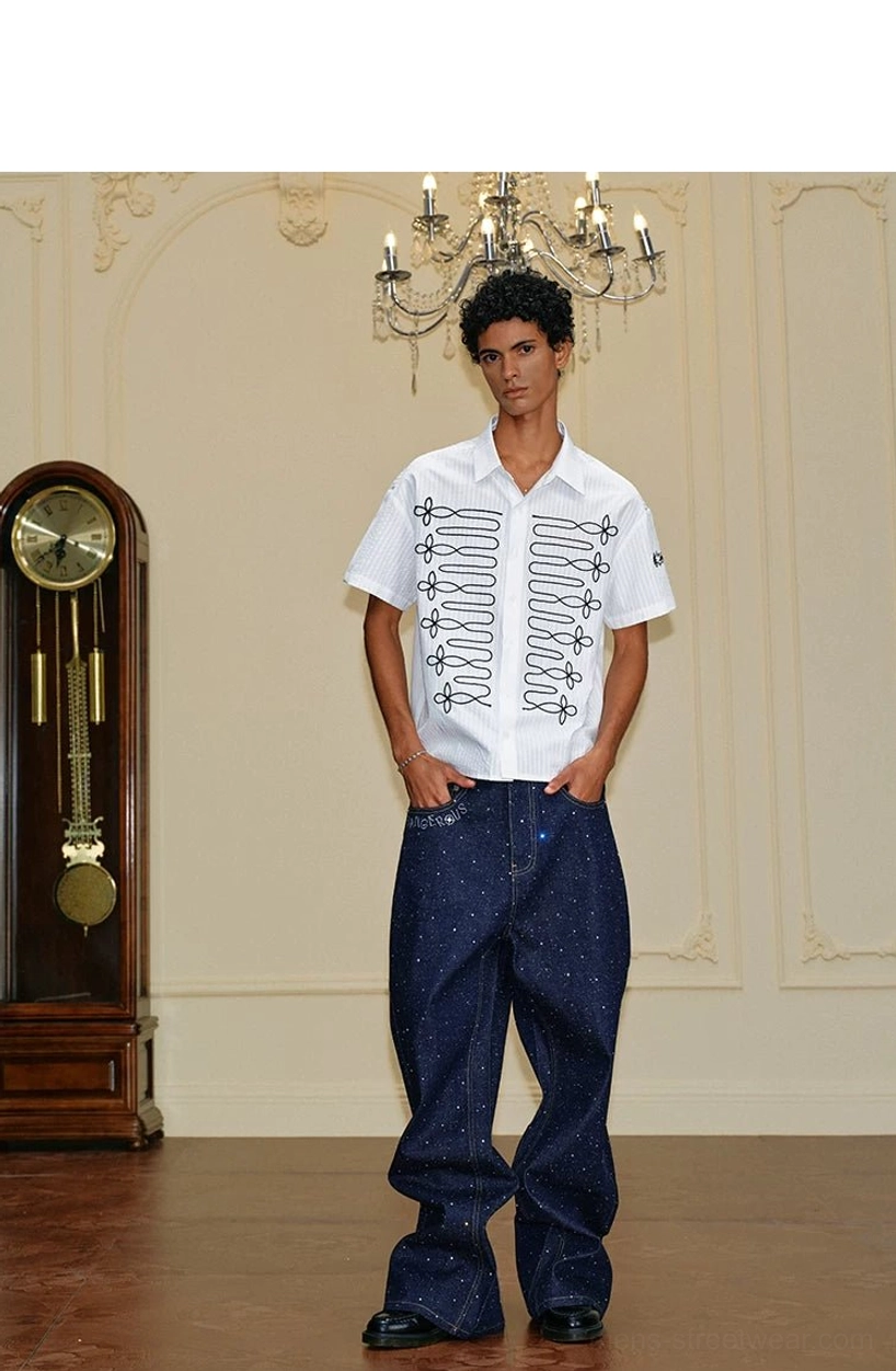 Full body view of relaxed white pinstripe embroidered short sleeve shirt with black loop design and dark denim