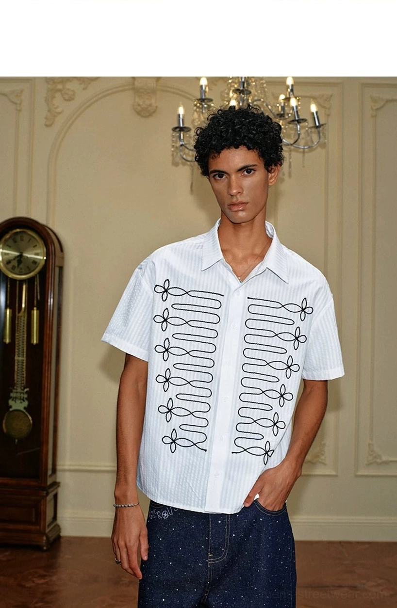 Front three-quarter view of Korean streetwear white pinstripe shirt with graphic black floral loop embroidery