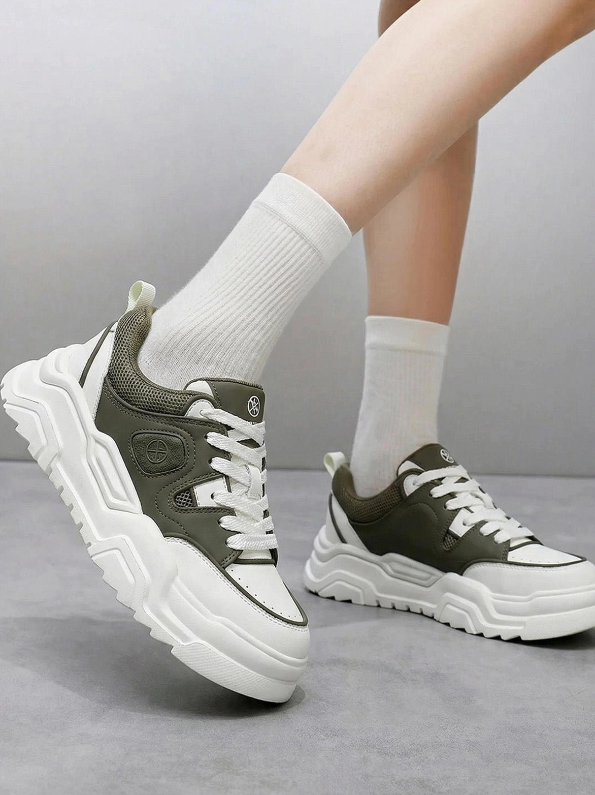 White platform sneaker rear heel view displaying heel counter structure pull tab design and back panel construction quality
