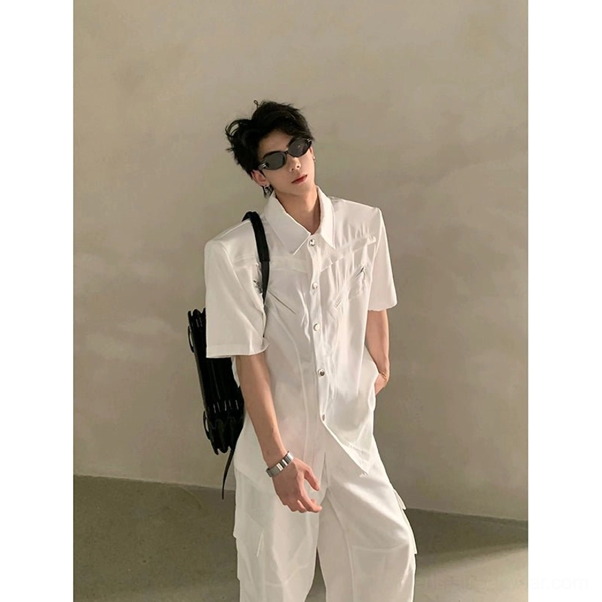 White pointed collar short sleeve utility shirt with structured silhouette, metallic button front, chest zipper detail, and modern Seoul fashion aesthetic