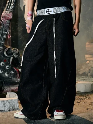 White platform canvas sneakers with red racing stripes styled with baggy black denim in an industrial retro streetwear outfit