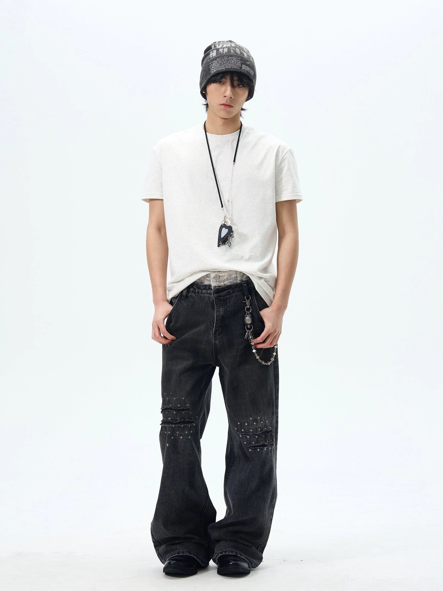 White relaxed crew neck t-shirt styled with a beanie, wide-leg studded jeans, pendant necklace, and jeans chain