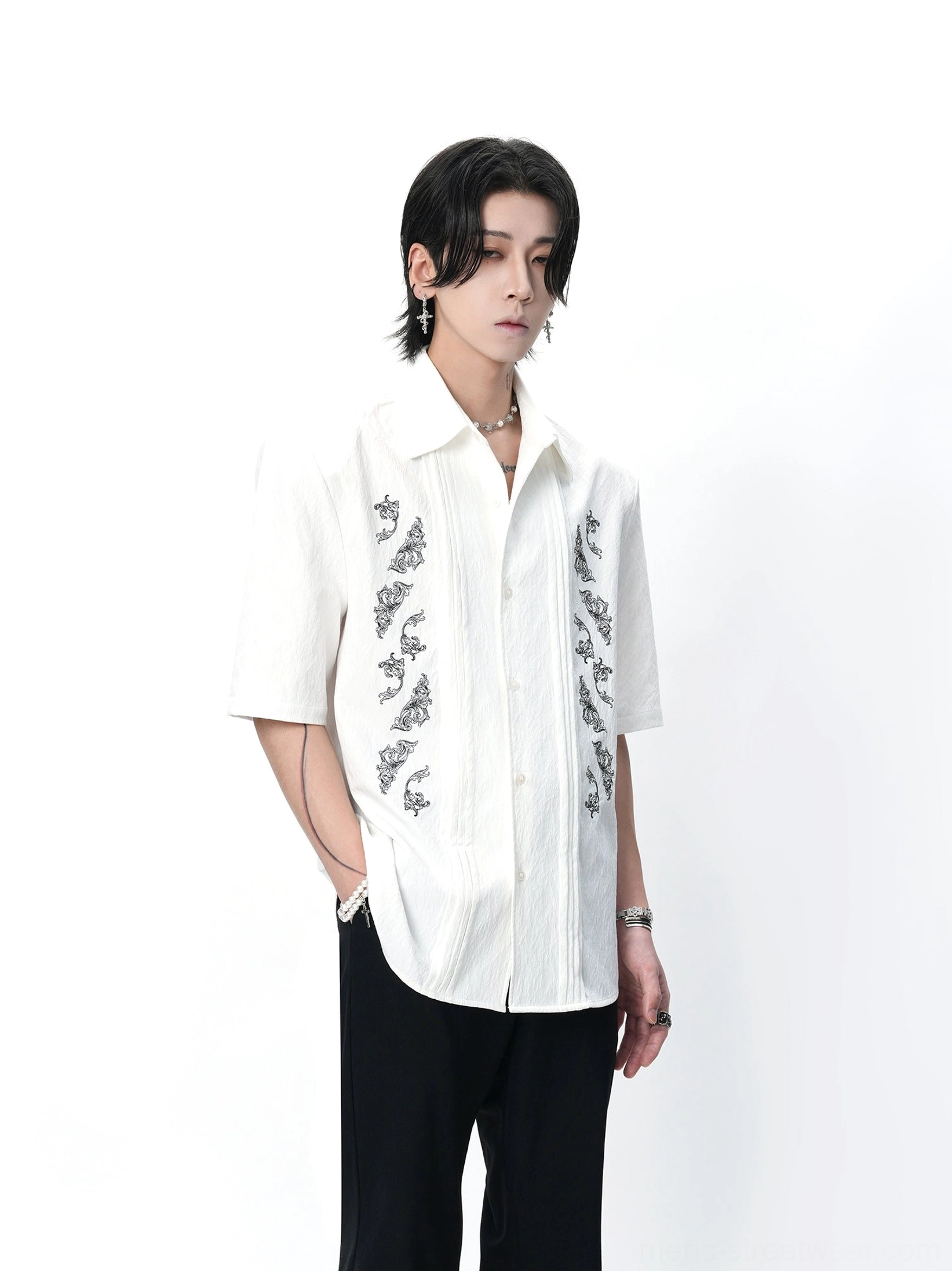 White relaxed fit dragon embroidered Cuban shirt shown in a three-quarter studio view with casual styling