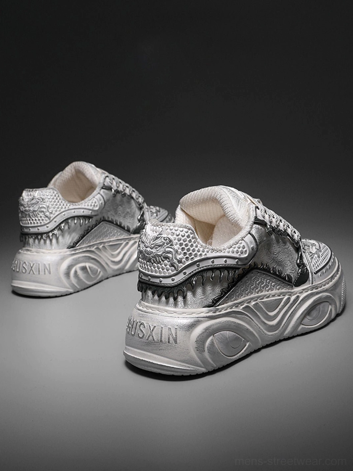 Rear angled view of white sculpted platform sneakers highlighting the textured upper and flowing wave-molded outsoles