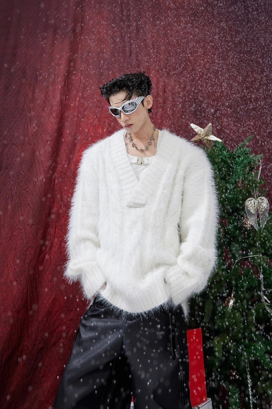 White shaggy faux-fur V-neck sweater with oversized unisex fit, layered jewelry, metal front accent, and winter holiday styling