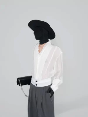 White sheer ruffle collar poet blouse styled with grey wide leg trousers, black wide brim hat, gloves, and chain handbag in Korean streetwear fashion