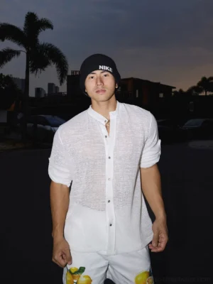 Front view of a white sheer textured stand collar shirt with relaxed Korean streetwear fit and rolled sleeves