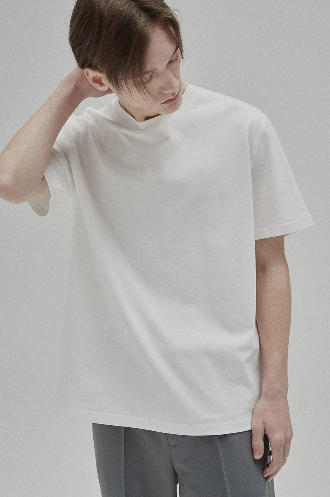 White short sleeve crew neck T-shirt close-up showing soft cotton knit texture and logo-free minimalist design