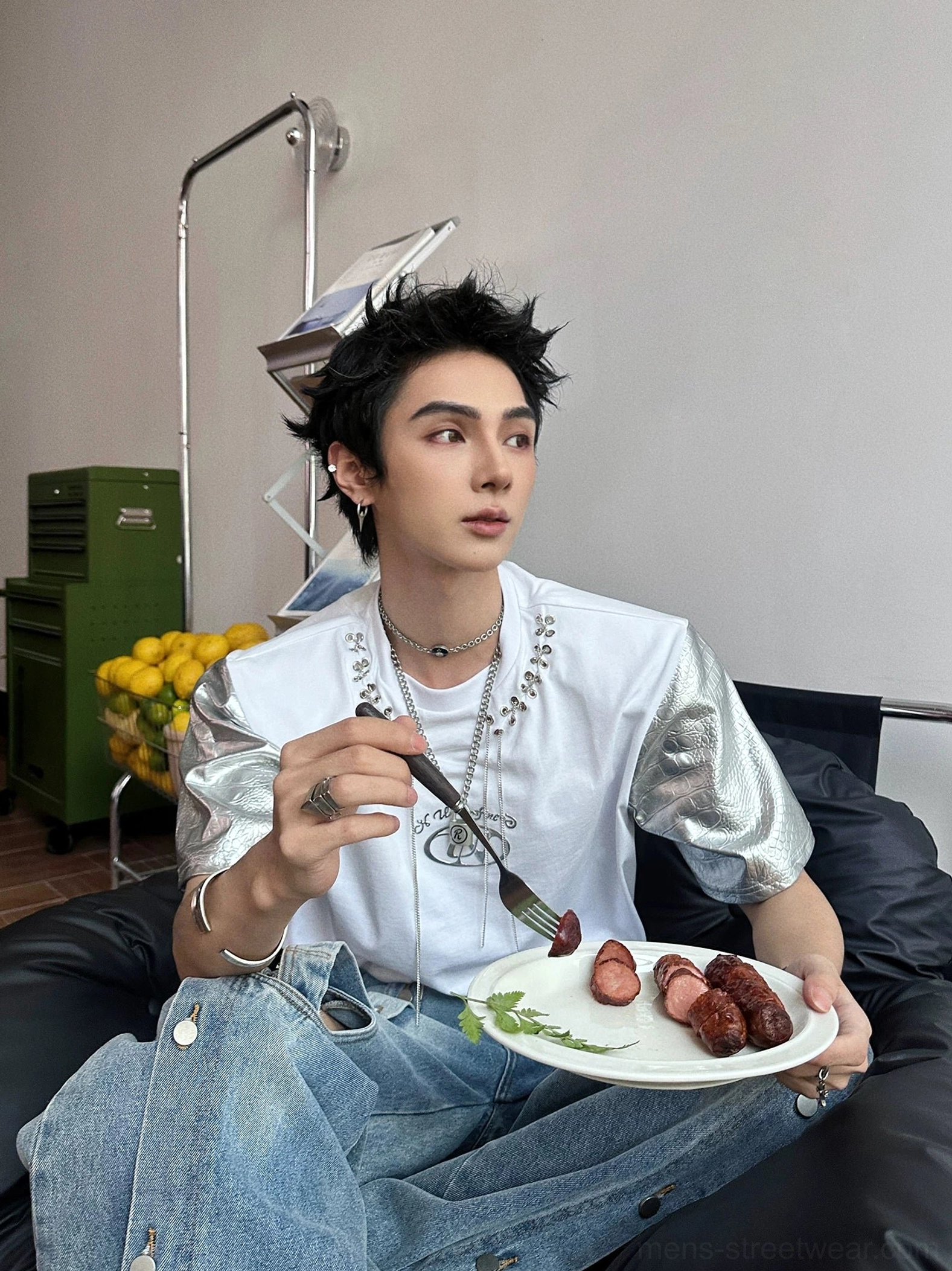 White silver paneled short-sleeve T-shirt with metallic faux-leather sleeves styled with wide-leg blue jeans and layered jewelry