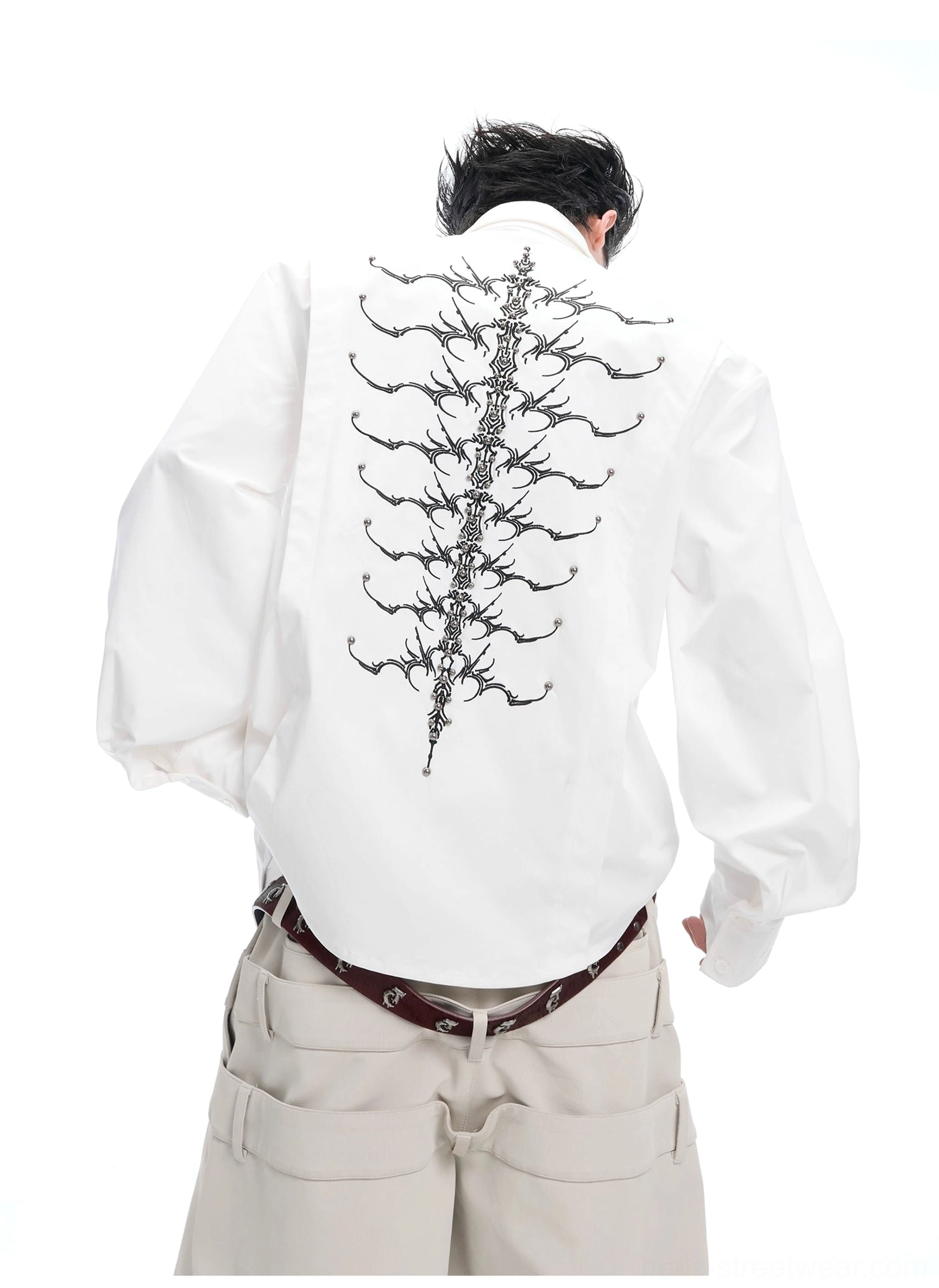 White spinal skeleton embroidered long sleeve shirt with loose fit styled with beige cargo pants and leather belt
