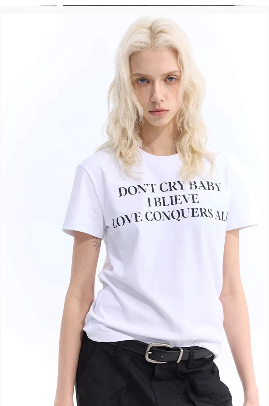 White slogan graphic T-shirt with black serif front print styled with belted black trousers