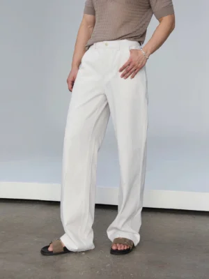 White relaxed straight leg denim jeans in a front three-quarter studio view showing the button waist and loose fit