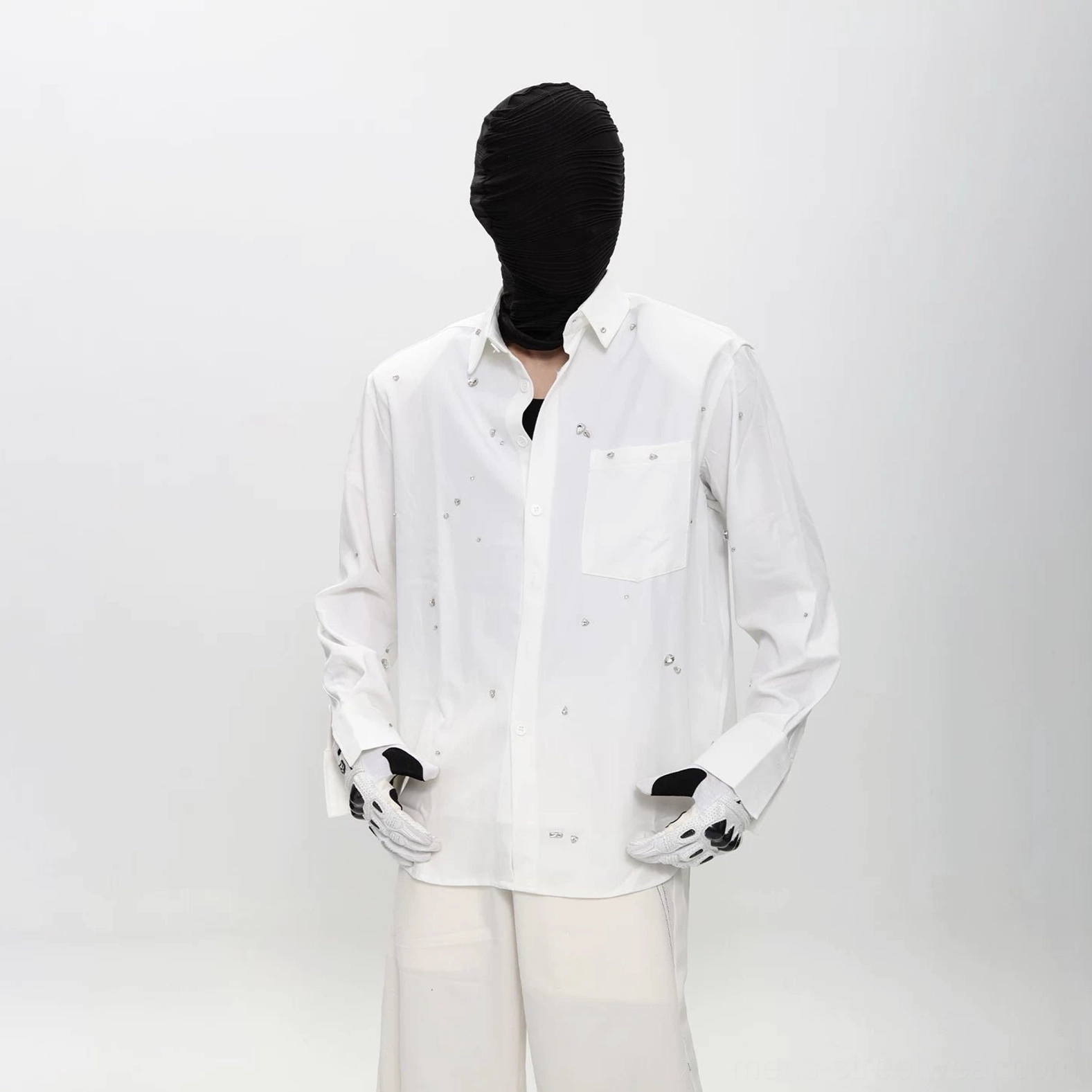 Three quarter front view of white speckled button up streetwear shirt with long sleeves, buttoned cuffs, and relaxed Korean silhouette
