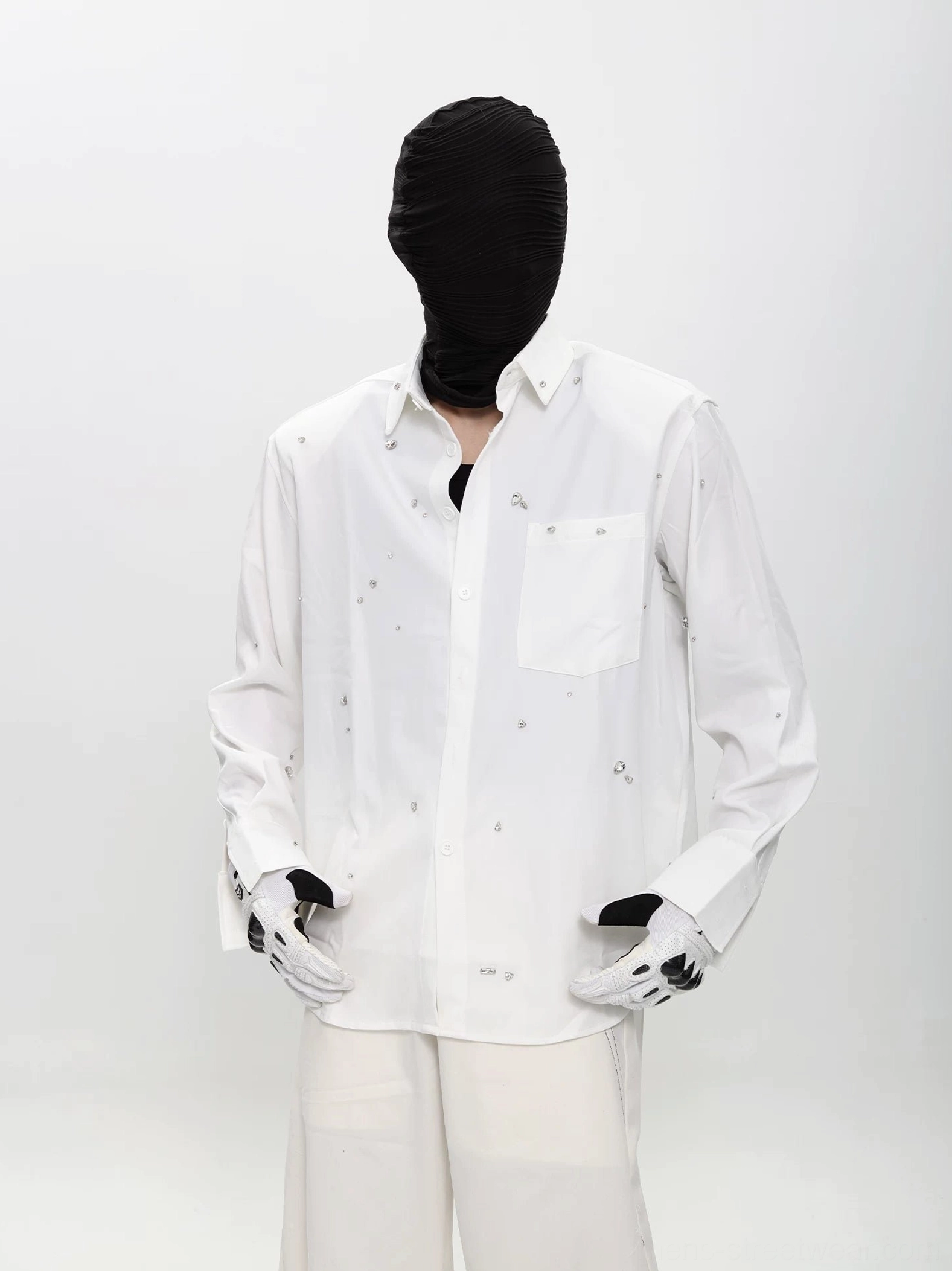 Full body front view of white speckled long sleeve streetwear shirt with classic collar, chest pocket, and wide leg trousers
