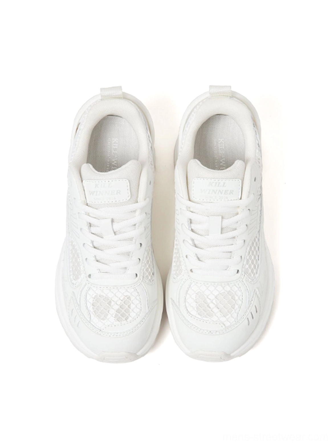 Top-down view of white technical runner sneakers showing the breathable mesh vamp, clean laces, and monochrome streetwear design