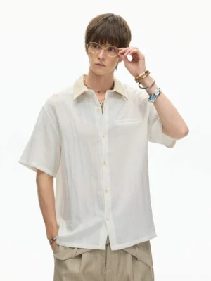 White textured contrast collar short sleeve streetwear shirt styled with beige wide leg trousers on a male model