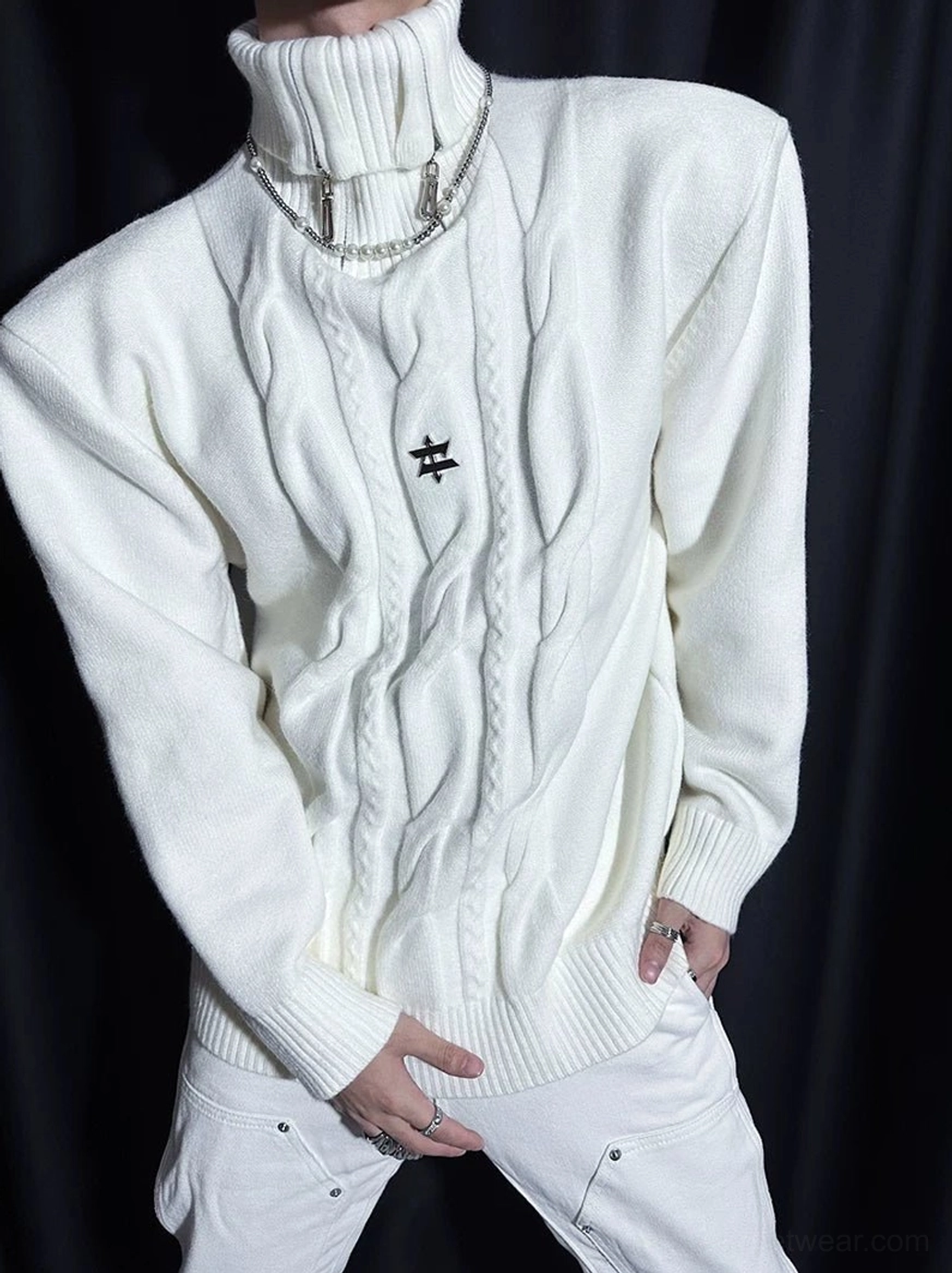 Close-up of white twisted cable knit turtleneck sweater with metal star emblem and ribbed sleeve cuffs