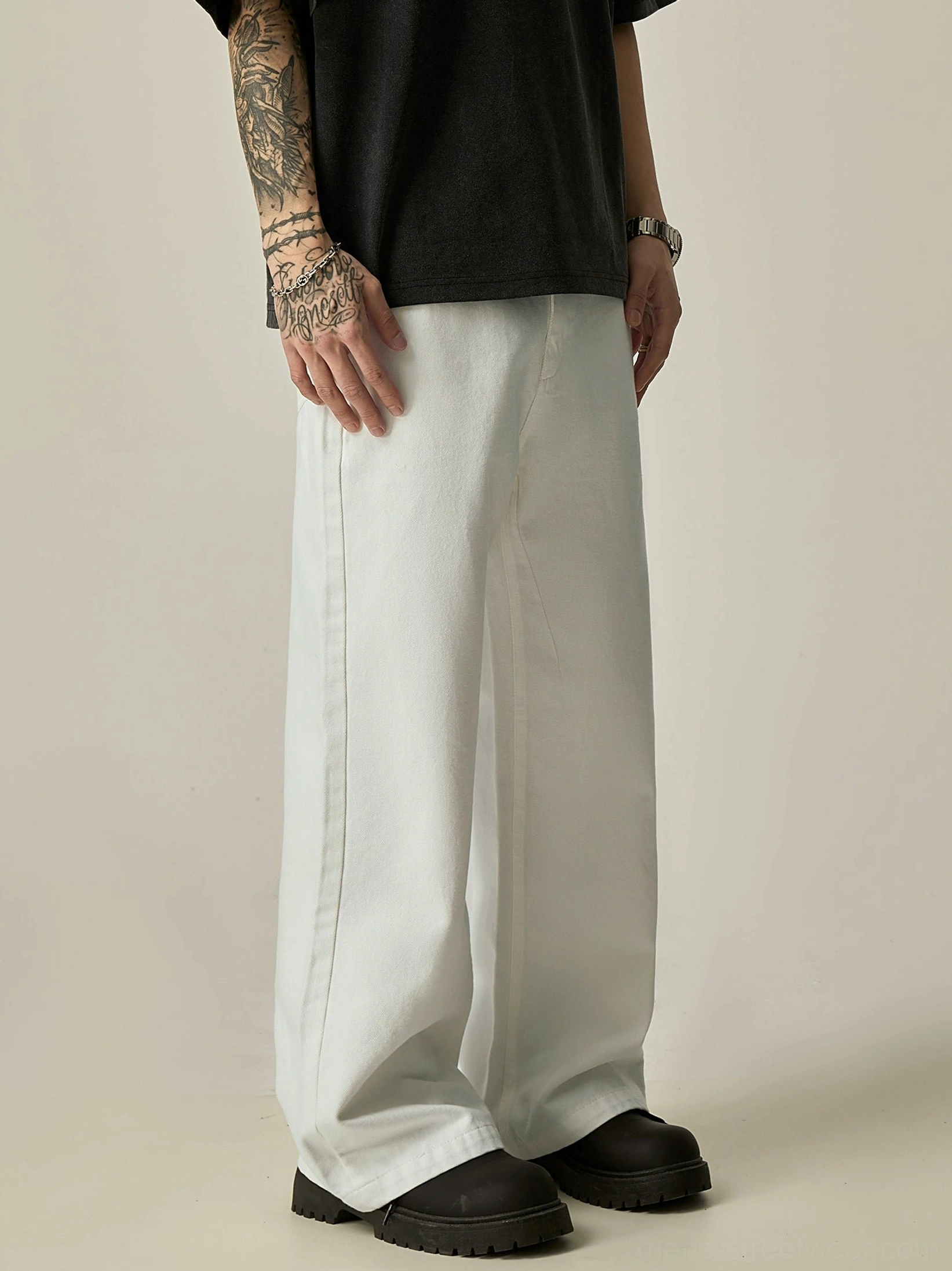 White ultra-wide jeans side view showing long relaxed leg drape and clean cotton denim texture